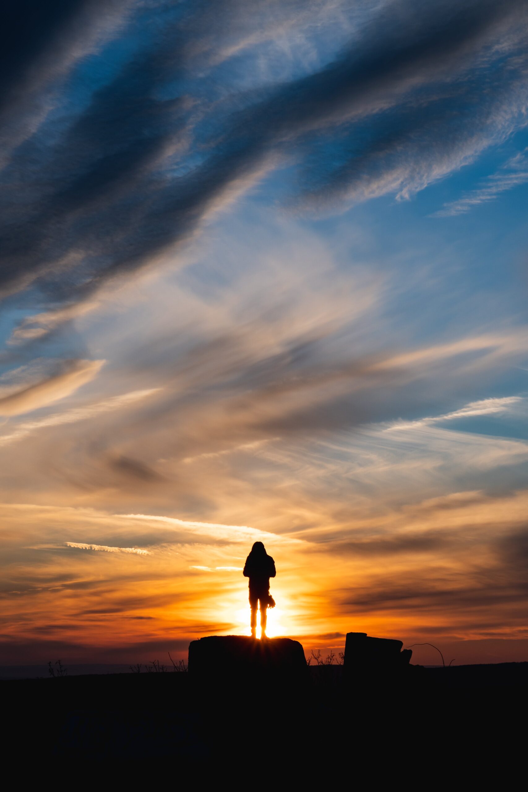 free from anxieties -image of person standing in the sunset